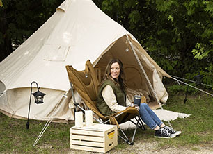 Girl by white canvas tent