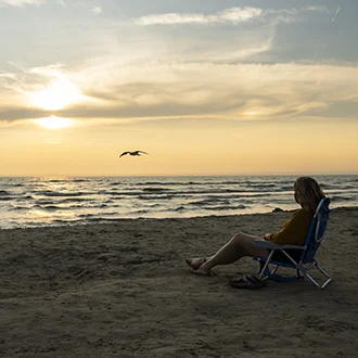 Lady relaxing in a chair at a beach