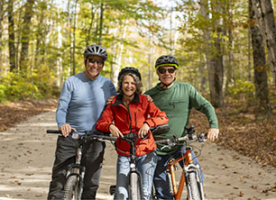 three cyclists on gravel road