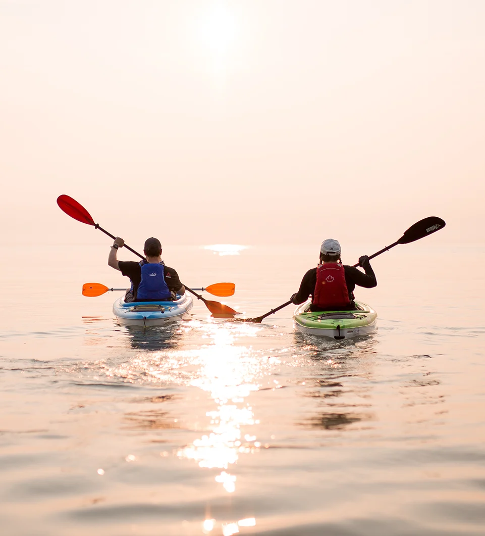 Two sets of kayaks on a lake